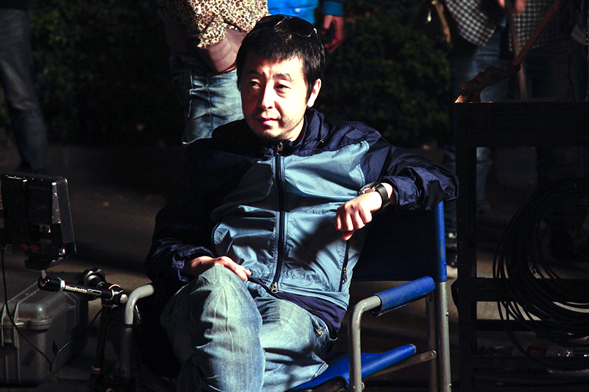 Chinese director Jia Zhang-ke on the set of “Mountains May Depart.” Via Kino Lorber.